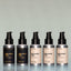 Five bottles of travel-size Beard Oil (Bold Fortune, Norse Winter, Old Money, Tree Ranger and Temple Smoke) side by side against a grey background.