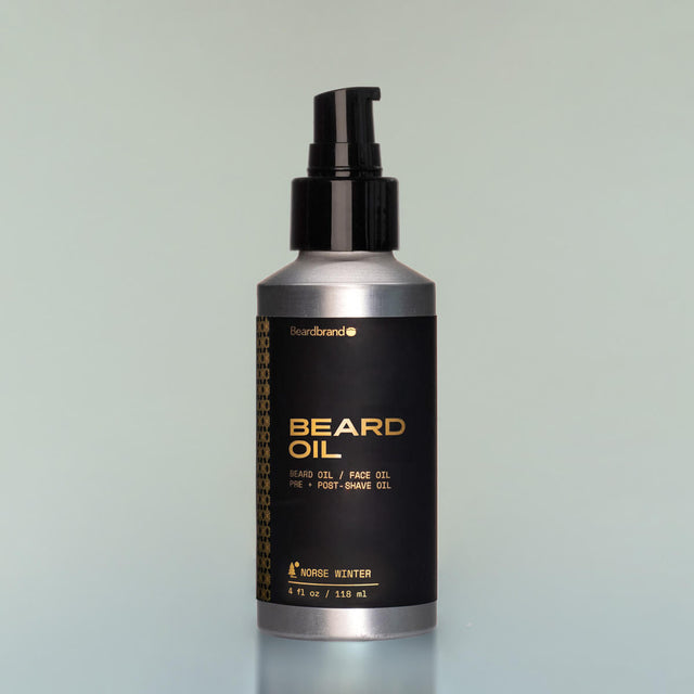 A bottle of Norse Winter full-size Beard Oil with a pump dispenser against a grey background.