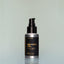 A bottle of Norse Winter travel-size Beard Oil with a pump dispenser against a grey background.
