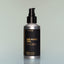 A bottle of Norse Winter full-size Beard Oil with a pump dispenser against a grey background.