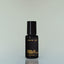 A bottle of Bold Fortune Eau de Parfum against a grey background.