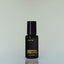 A bottle of Norse Winter Eau de Parfum against a grey background.