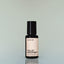 A bottle of Old Money Eau de Parfum against a grey background.