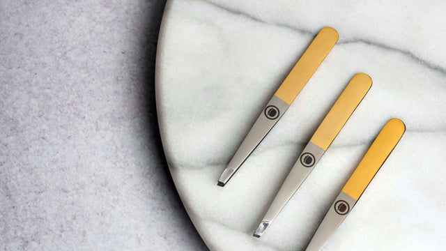 3 Tweezers in a diagonal row on a granite circle