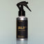 A bottle of Norse Winter Sea Salt Spray with a sprayer dispenser against a grey background.