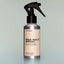 A bottle of Temple Smoke Sea Salt Spray with a sprayer dispenser against a grey background.