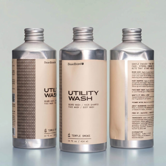 Three Beardbrand Temple Smoke Utility Wash bottles showing dented aluminum packaging from multiple angles.