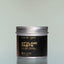 A container of Bold Fortune Styling Paste against a grey background.