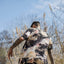 Carlos walking away from the camera in a wild field.